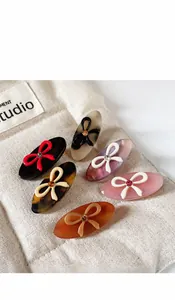 Detail view of colorful acetic acid bow hair clips with rhinestones in six colors