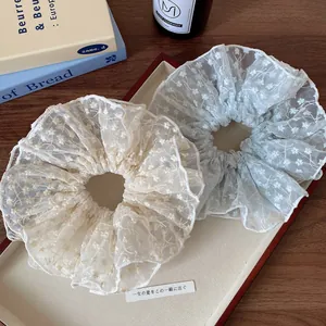 French vintage style lace floral scrunchies in cream and blue colors on a tray