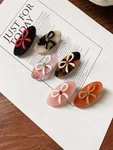 Set of 6 colorful acetate hair clips with crystal studded bows on elegant card