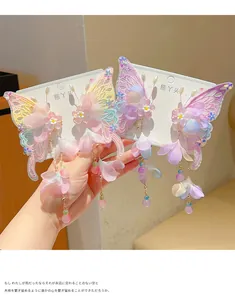 Detailed view of butterfly hair clips with colorful embroidery and beaded tassels