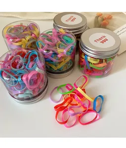 Detailed view of colorful elastic hair bands in clear jars with silver metal lids