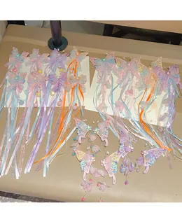 Close-up of butterfly hair clips with long tassels, lace wings and pearls for girls