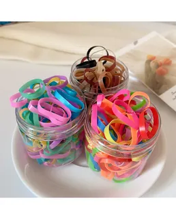 Assorted colorful high-elastic hair bands in transparent storage jars for easy organization