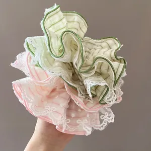 Oversized mint green and pink plaid scrunchie with floral lace edges and ruffles