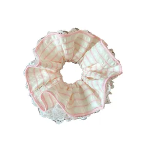 Pink and white striped scrunchie with lace trim and sweet bow design for women
