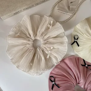Elegant oversized scrunchies in cream and pink with pearl and bow details