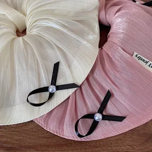 Lustrous pleated scrunchies with bow and pearl in cream and dusty pink tones