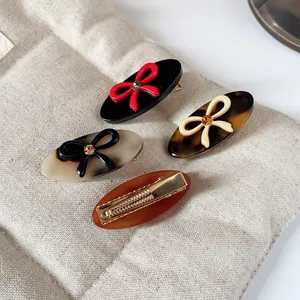 Retro acetate bow hair clips with crystal accents and metal duckbill clamps in four colors