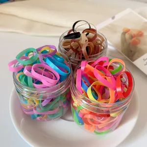 Elastic colorful hair bands set in three clear jars for kids hair styling and braiding
