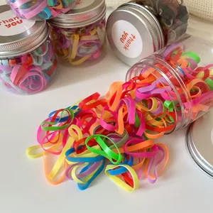 Colorful elastic hair bands set in a clear jar with a silver lid and thank you label
