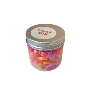 Colorful baby hair elastic bands in clear jar with thank you label on silver lid