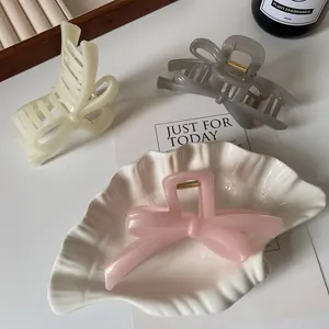 Elegant large bow hair claws in cream, grey, and pearl pink with gold metal springs