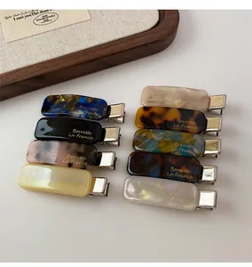 Set of 9 acetate rectangular hair clips in various colors like tortoiseshell and marble