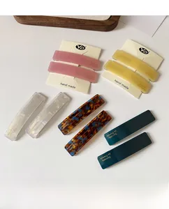 Close-up of assorted rectangle acetate hair clips in matte and glossy textures