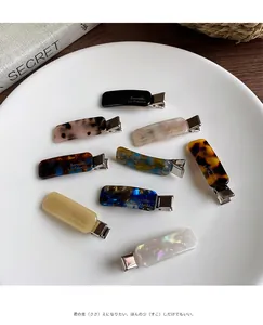 Detailed set of premium acetate rectangular hair clips in eight assorted marble patterns