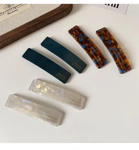 Detailed set of six acetate hair clips in pearl white, blue tortoise, and teal colors