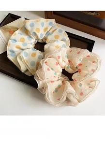 Detail of sweet organza scrunchies with polka dots and hearts on a vintage tray