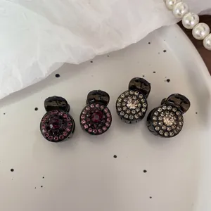 Set of 4 mini crystal claw clips for hair styling featuring purple and white rhinestones
