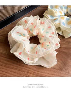Close-up of organza scrunchies with colorful polka dots on a wooden background