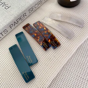 French style acetate hair clips set in dark green, tortoiseshell, and matte white