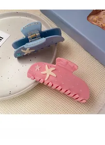 Detail of pink and blue acetate starfish hair claws with pearly bead decorations
