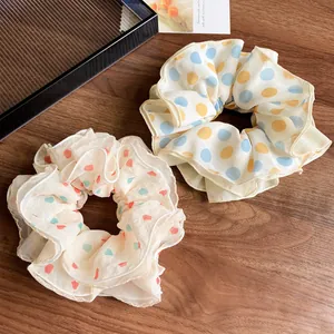 Chiffon scrunchies with sweet heart and polka dot prints on dark wooden background