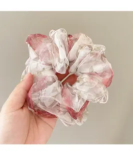 Detail of floral organza scrunchie featuring vintage red roses and translucent fabric