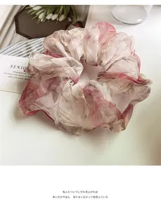 Detail of floral organza scrunchie with French vintage pattern and soft texture