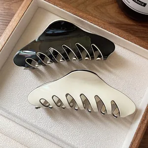 Classic French hair claw clips in black and cream white with polished glossy finish