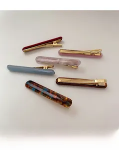 Detailed set of six colorful acetate hair barrettes with gold clips in assorted patterns