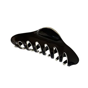 Classic French hair claw clip in black and cream contrast with glossy finish for women