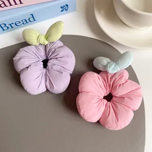 Sweet floral fabric scrunchies in pastel purple and pink with leaf bow knot accents