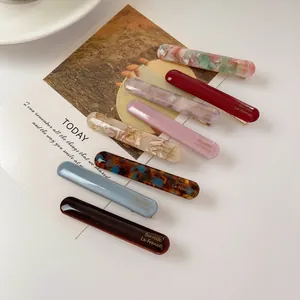 Set of minimalist acetate hair clips in multiple colors with French style lettering