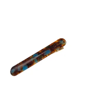 Tortoiseshell acetate hair clip in blue and amber tones with gold metal spring barrette