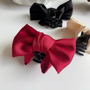 Elegant oversized satin bow hair claw clip in deep red, black and cream colors