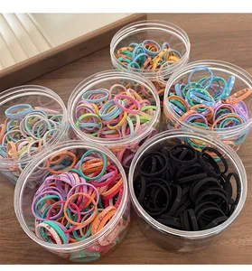 Detailed view of six clear jars containing colorful high-elastic hair ties for girls