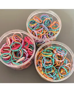 Detail of colorful elastic hair bands with cherry and heart prints in clear storage jars