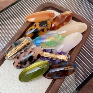 Vintage acetate hair clips set with oval tortoise shell patterns and metal duckbill clips