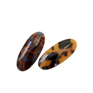 Set of two vintage acetate oval hair clips with tortoise shell pattern and gold handmade text