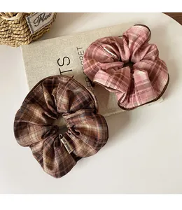 Detailed macro view of vintage plaid scrunchies featuring fine stitching and fabric texture