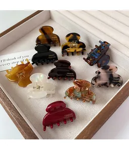 Collection of mini acetate hair claws in leopard and marble patterns with gold lettering