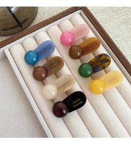 Detail of 8pcs colorful acetate hair clips with France Handmade text on velvet tray