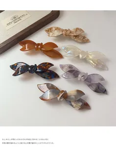 Detailed top view of six colorful acetic acid bow spring hair clips with marble patterns