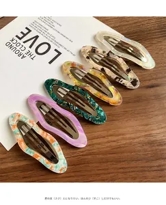 Close-up of 6-piece acetate hair clips set with colorful marble and floral patterns