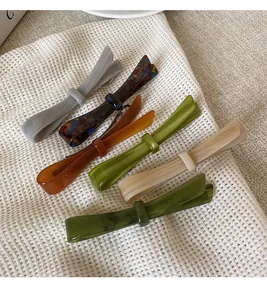 Detailed collection of acetate bow hair clips in various tortoise shell and solid colors