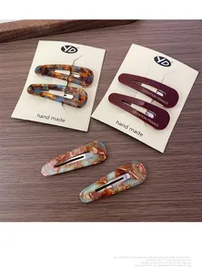Close-up of French vintage tortoiseshell hair clips with gold lettering on display cards