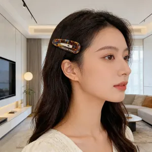 French vintage tortoiseshell BB hair clip with gold lettering worn by model side view