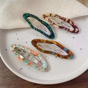 Set of four cute cloud-shaped acetate snap hair clips in diverse floral and marbled colors