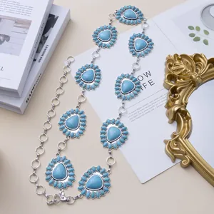 Bohemian turquoise heart waist chain with silver sun flower pendants on white background