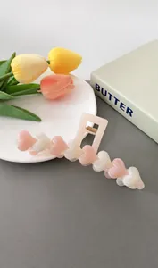 Detail showing pink and white heart hair claw clip with 13cm size measurements